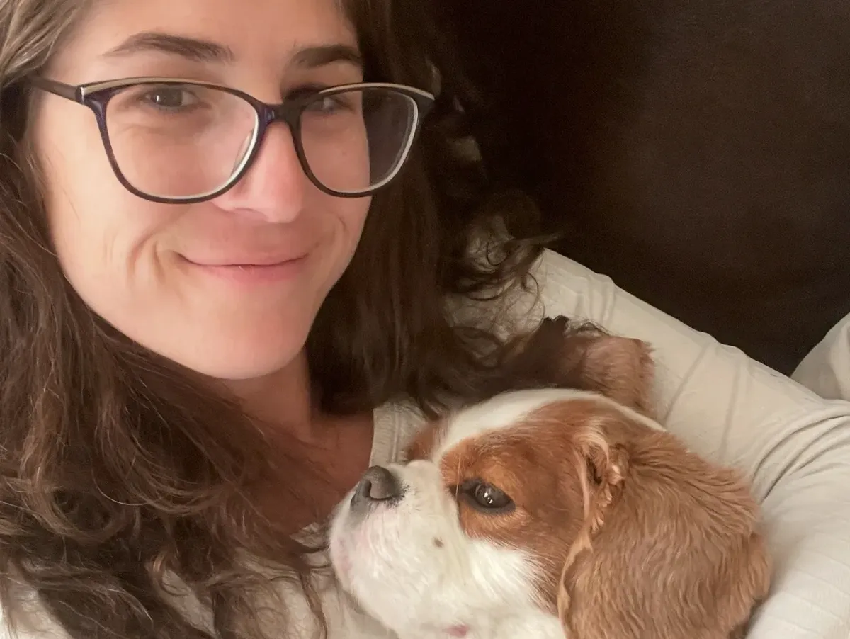 A happy woman with her obedient puppy