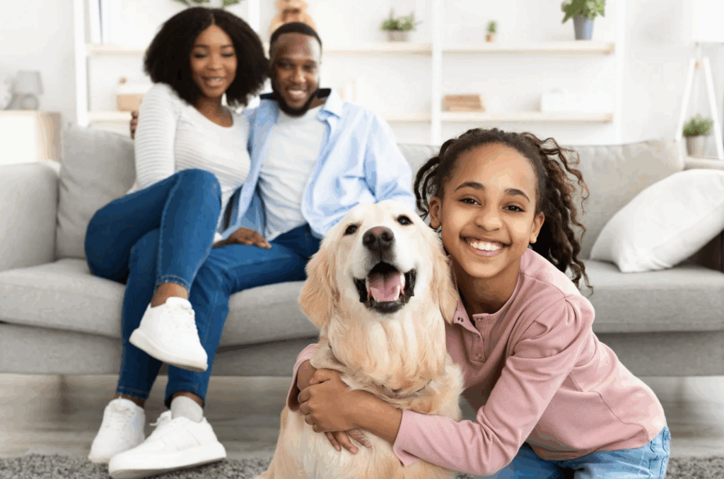 Family happily socializing at home with their dog
