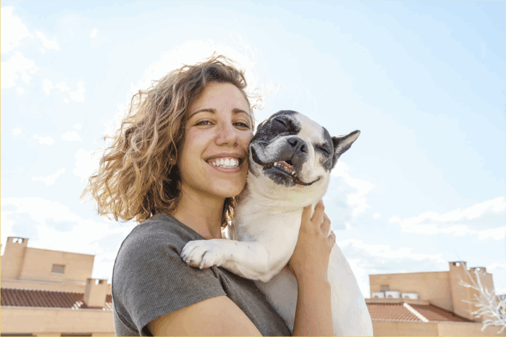 A woman snuggling with her support animal