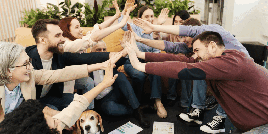 Group of people with dogs high-fiving