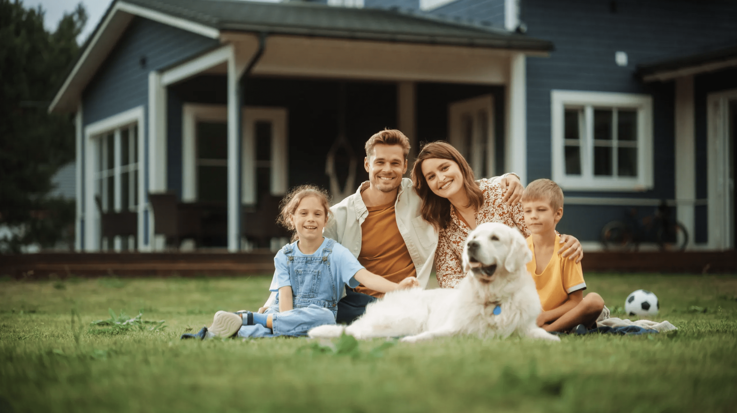 Family sitting outside with dog off leash