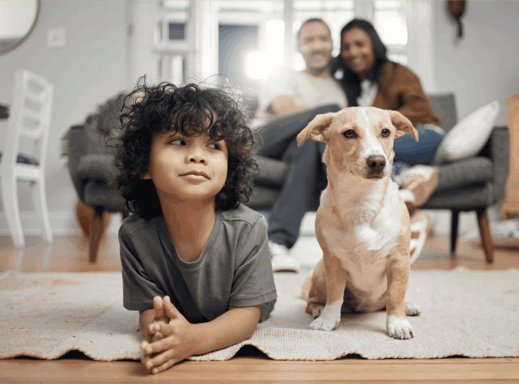 a puppy sitting next to a child