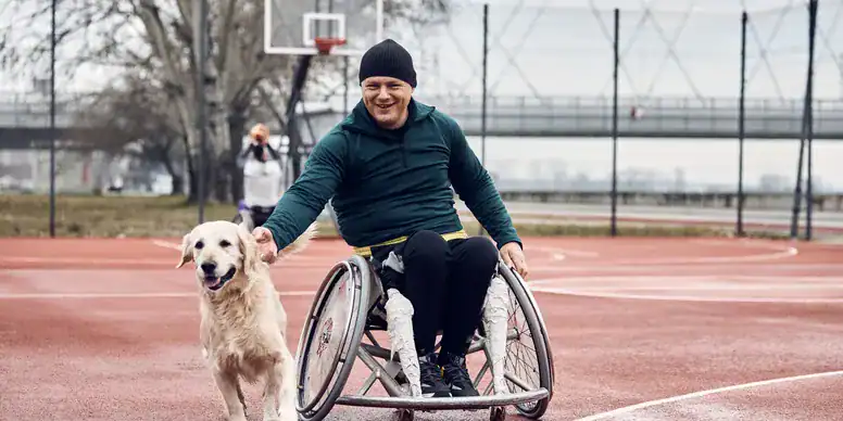 Service dog helping man in wheelchair